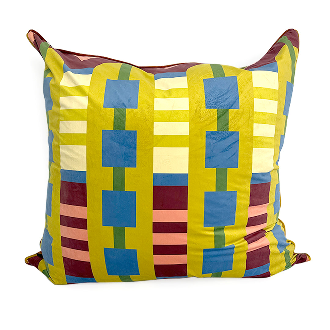 Colorful geometric velvet patterned pillow on a white background