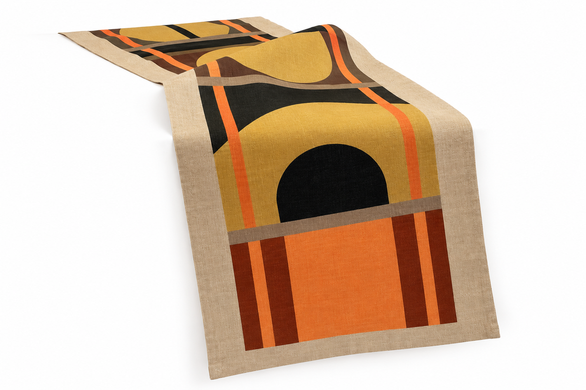 Lulasclan Designer patterned table runner with 100% Linen & cotton base features geometric symbols and motives in tan, tangerine and deep terracotta, strips cover the design's borders and is placed set against a white background.