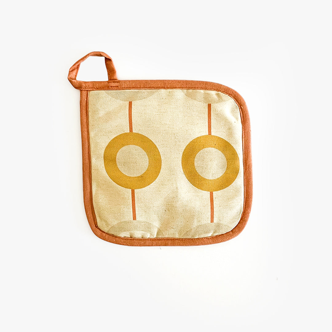Pot holder featuring African printed homeware fabric for contemporary kitchen Home in neutral apricot colours