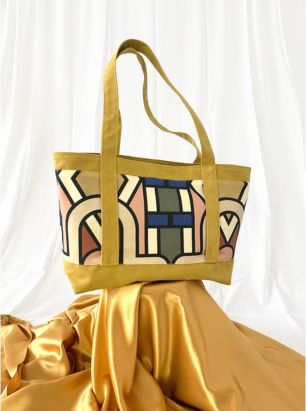 Yellow tote bag with abstract pattern on a white background