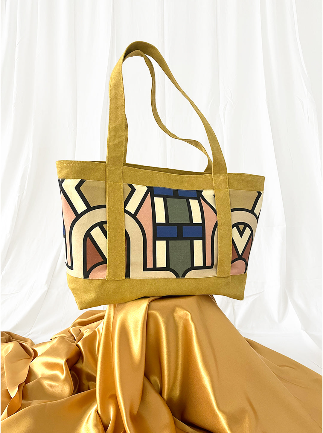 Yellow tote bag with abstract pattern on a white background