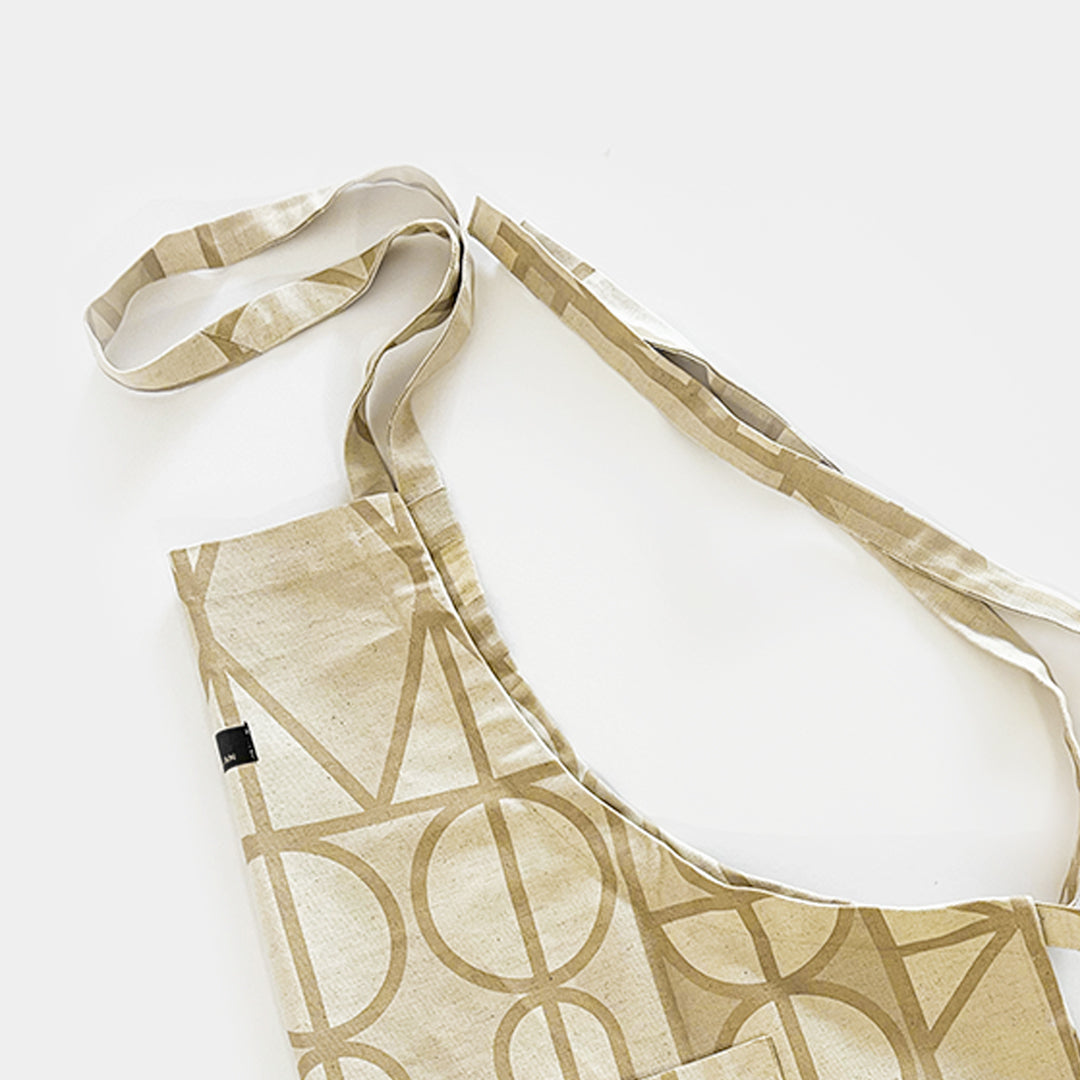 Legae Peace neutral coloured apron, with adjustable straps made in Cape Town South Africa.