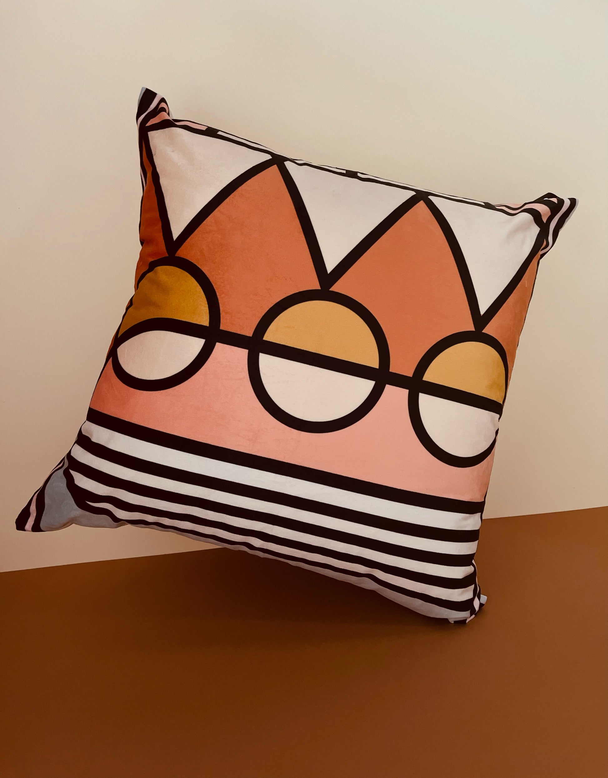 Orange, peach velvet 60cm x 60cm geometric decorative scatter cushion with circle and triangle pattern and plain matching background for bedroom and living room.